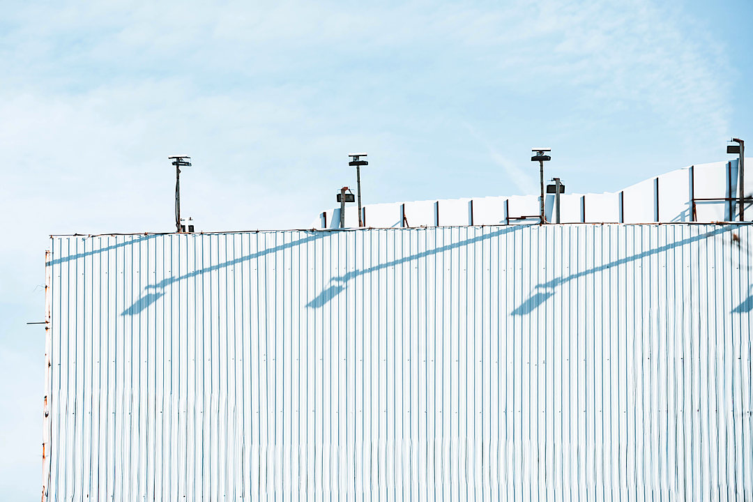 Minimalist industrial building roofline against the sky